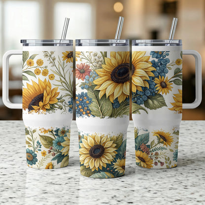 Three tumblers with floral sunflower and blue accent flower designs.